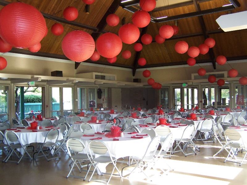 The reception hall is decorated in flowers and large balloons for a wedding
