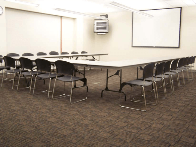 The room is set up in a U-Shape layout for a meeting