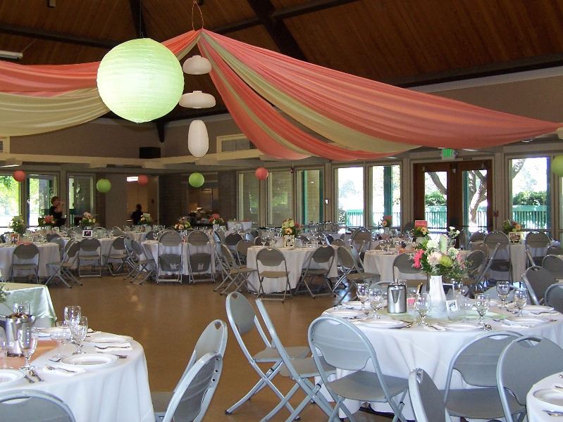The reception hall is decorated in flowers and streamers for a wedding