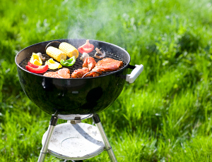An appetizing assortment of veggies and meat sizzle on a charcoal grill.
