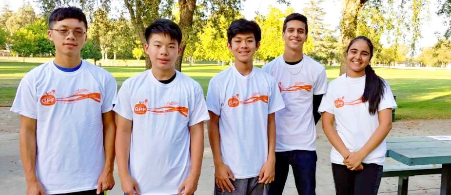 Five Pumpkin Festival Volunteers with white shirts 