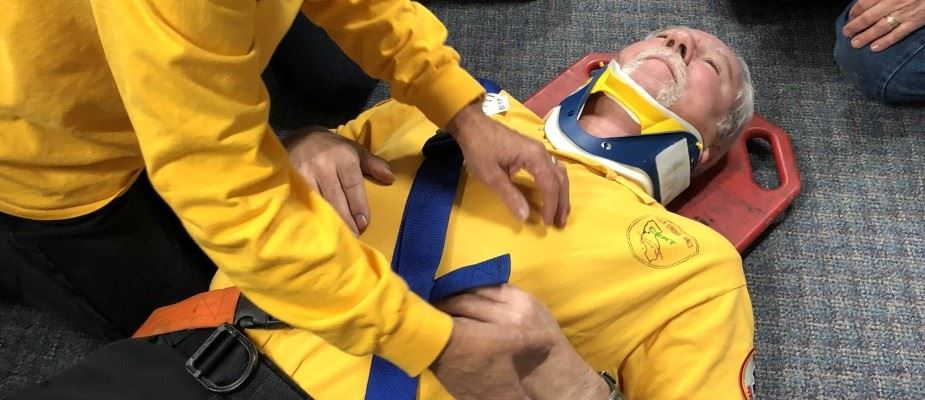 Picture of person on backboard during CERT training