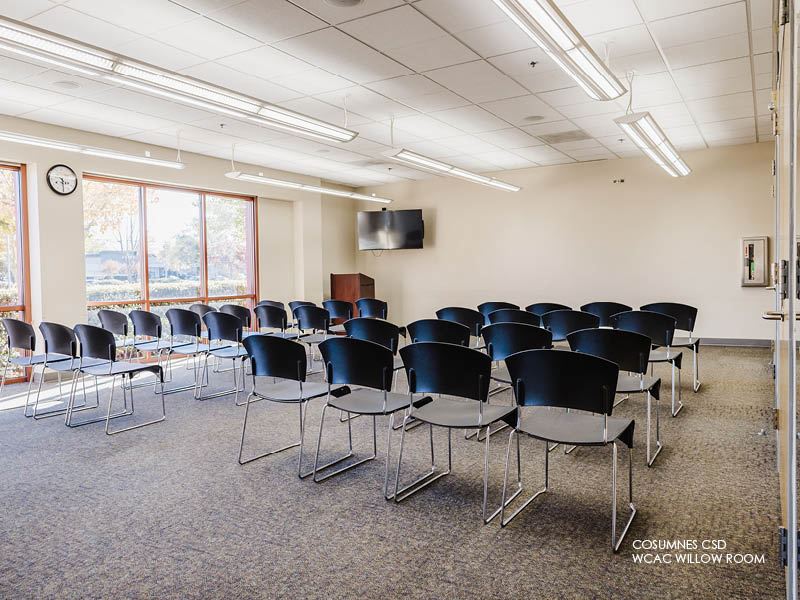 Image of Cosumnes CSD WCAC, Willow Room with rows of chairs, podium and TV.