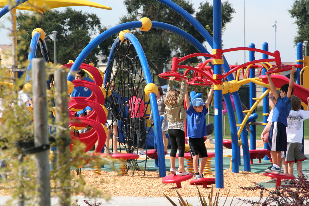 Children laugh and play on the playground at Bartholomew Sports Park