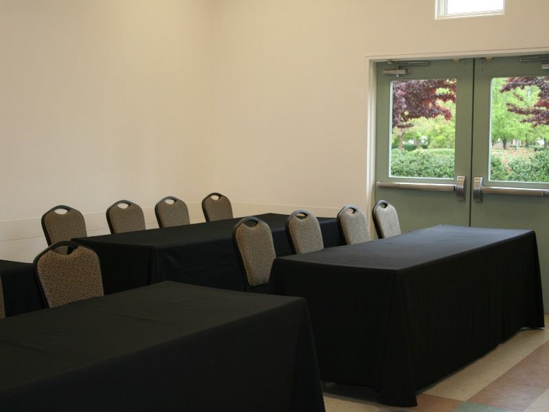 Room 1 set up for a meeting with tables and chairs