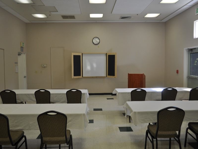 Room 2 set up for a meeting with tables and chairs